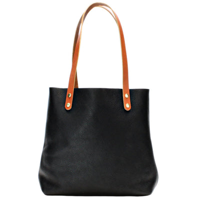 Black with brown straps handmade leather tote bag by Kerry Noël.